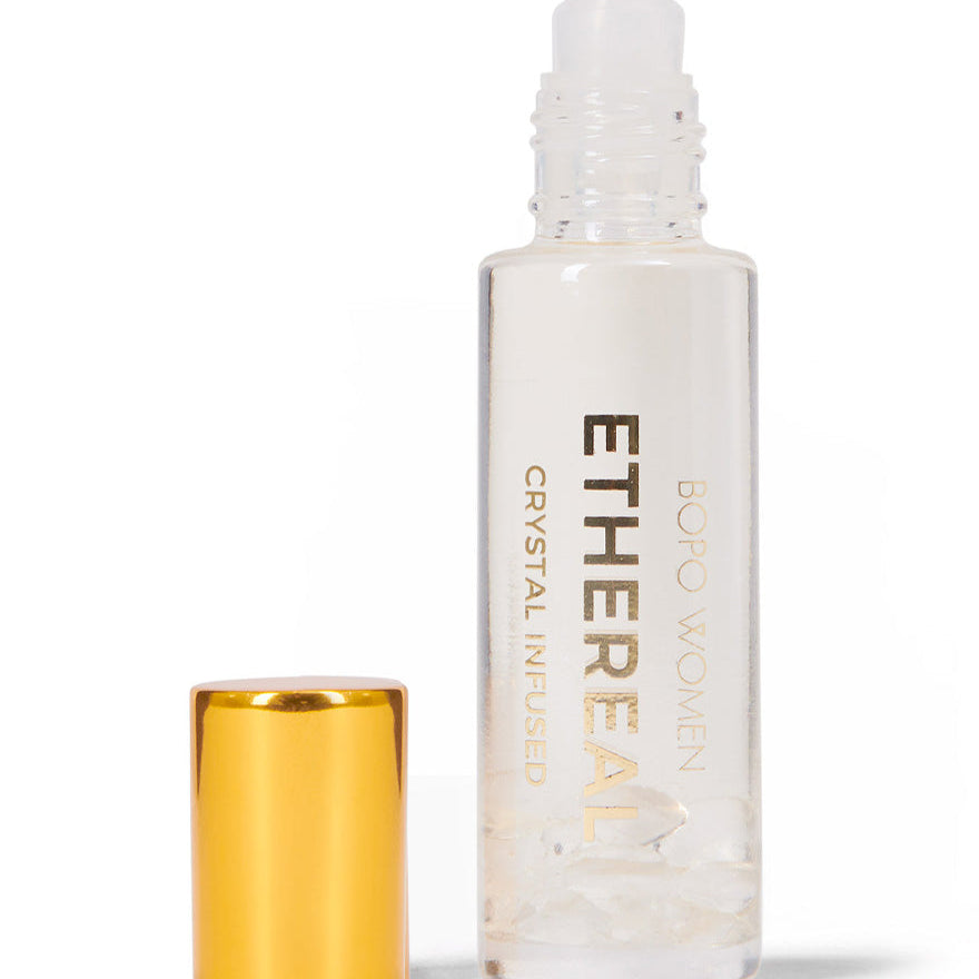 Ethereal rollerball bottle with gold cap on a white background