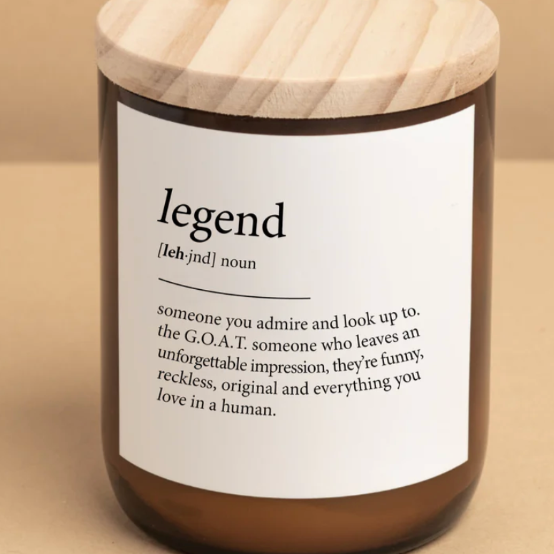 Candle with a wooden lid and label defining 'legend' on a beige background