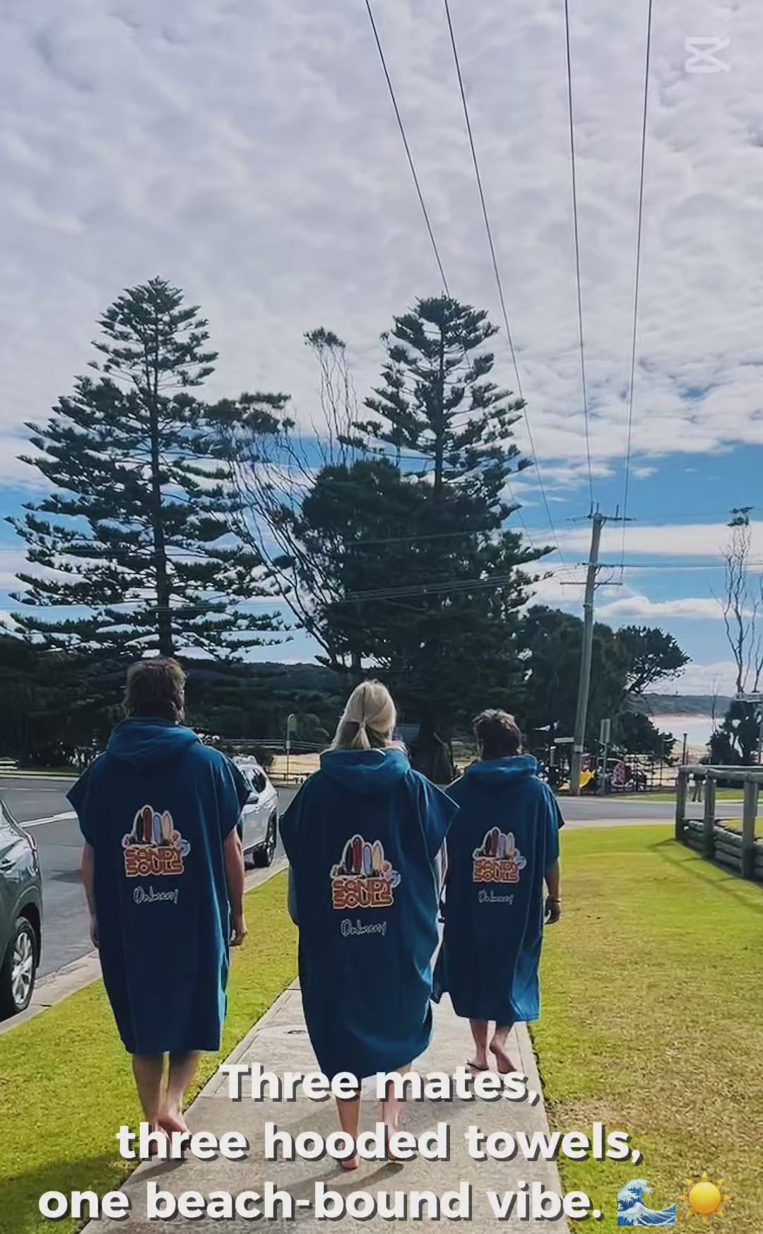 3 people in teal hooded towells