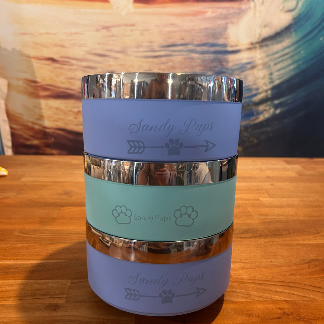 Clear container with purple and green labels on a wooden surface