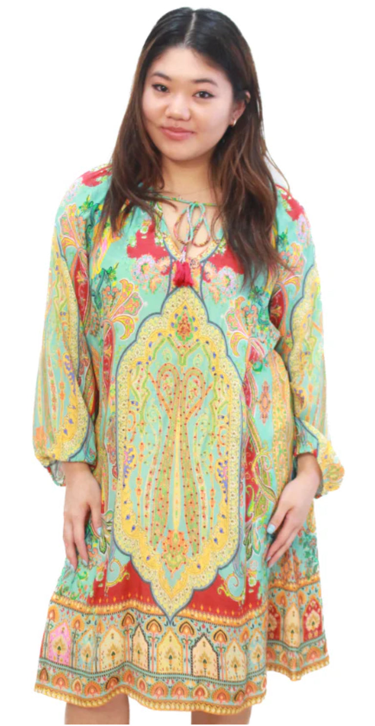 Woman wearing a colorful patterned dress on a white background