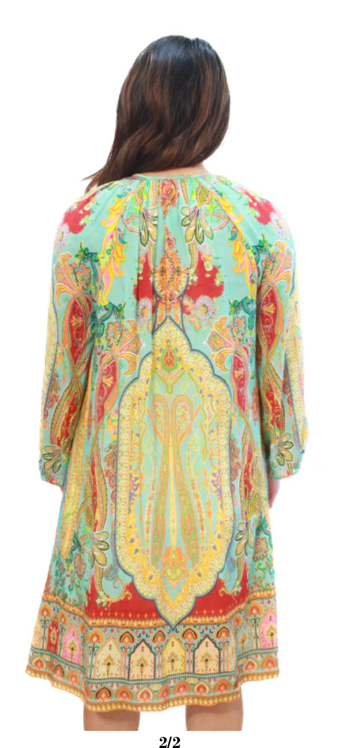 Woman wearing a colorful patterned dress with a white background