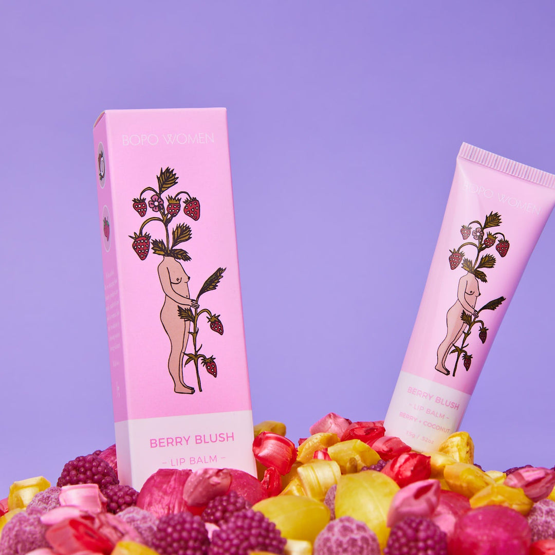 Pink skincare product packaging with illustrations on a purple background