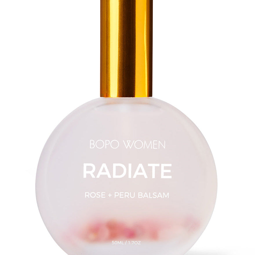 Perfume bottle labeled 'Radiate' by Bopo Women with a gold cap on a white background