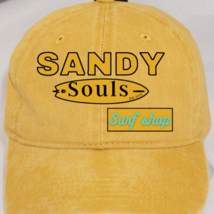 Yellow cap with 'Sandy Souls Surf Shop' text on a white background