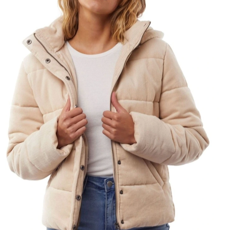 Beige puffer jacket worn by a person on a white background