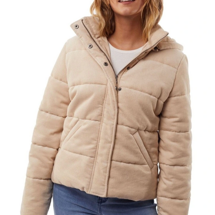 Beige puffer jacket worn by a person on a white background