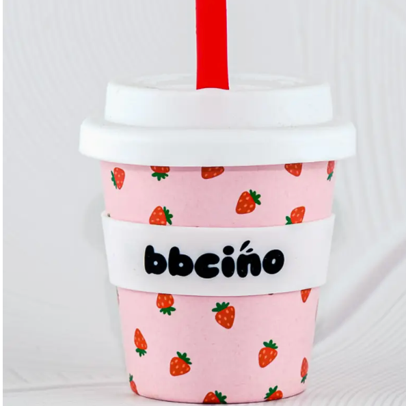 Pink coffee cup sleeve with strawberry pattern and 'bbciño' branding on a white background