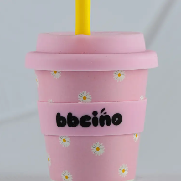 Pink tumbler with floral pattern and 'bbcino' branding on a light gray background