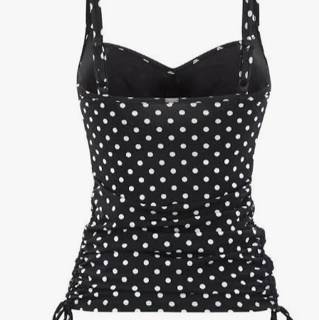 Black tank top with white polka dots on a white background