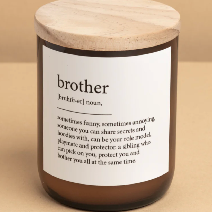 Candle with a label defining 'brother' on a beige background