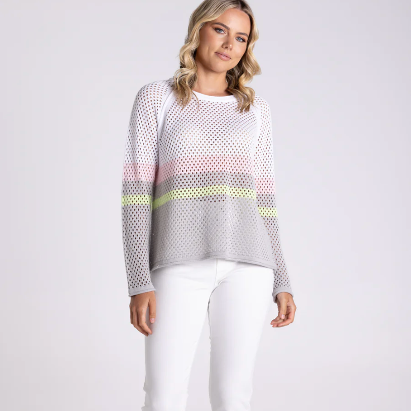Woman wearing a white and gray patterned top with a yellow accent on a white background